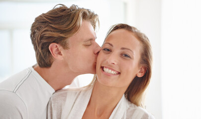 We cant get enough of each other. A happy young couple having an intimate moment in their home.