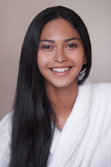 Shes excited for her day of pampering. Studio shot of a beautiful young woman in a bathroom.