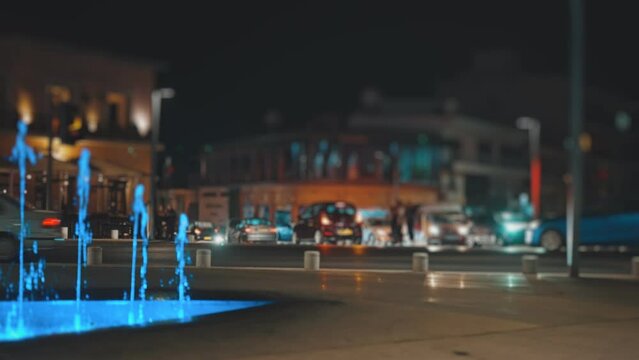 Illuminated fountain in the center of Paphos at night.