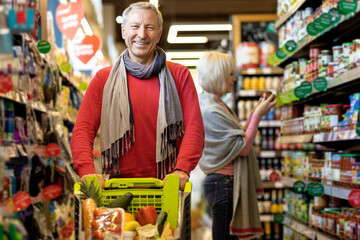 Happy senior man enjoying shopping with his wife