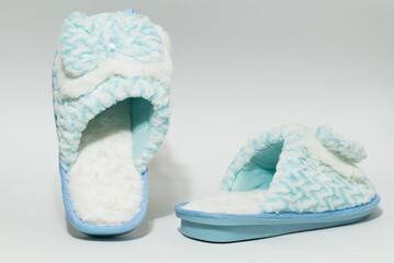women's blue slippers in different poses with a white background