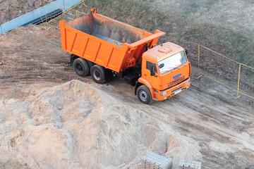 Construction works for laying pipes. Dump trucks involved in the excavation of the earth