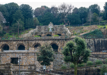 Fototapeta premium Old fountain with waterfall and greenery