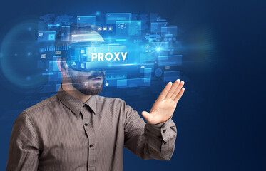 Obraz premium Businessman looking through Virtual Reality glasses
