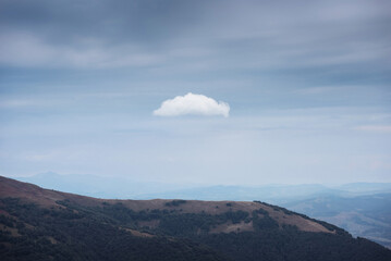 White cloud hovering over the mountain. Minimalistic picture of Borzhava mountain range,...