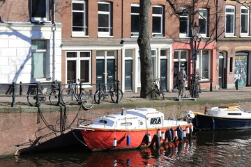 Fototapeta na wymiar Amsterdam Lijnbaansgracht Canal View with Red Boat and Brick House Facades, Netherlands