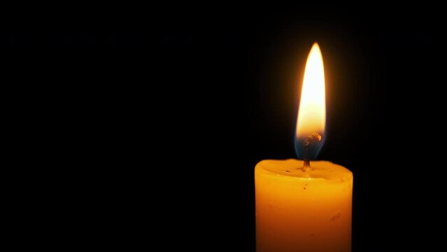 Candle Flame with Alpha Channel. The candle burns with a soft yellow flame. Candlelight, isolated. Close-up, slow motion. Candle lit on transparent background. Life, remembrance, or celebration. 4K