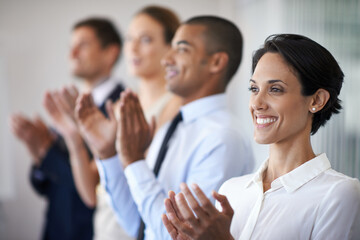 Obraz premium Thats something to celebrate. Shot of a row of smiling colleagues clapping.