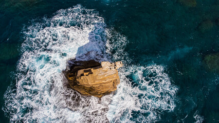 Scenic aerial top down shot of the biazarre rock formations of Triopetra beach in Crete, Greece