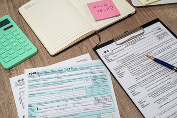 many us tax form 1040 w4 w9 on office desk. financial documents