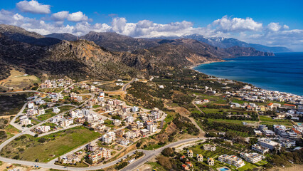 Scenic aerial shot of Paleochora and the coastline with the white mountains in crete, Greece