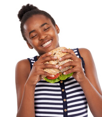 This a darn good sandwich. Shot of a happy young african american girl holding a salad sandwich isolated on white. - obrazy, fototapety, plakaty