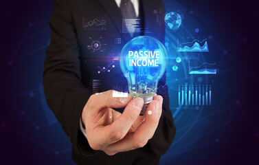 Businessman holding a light bulb, new business concept