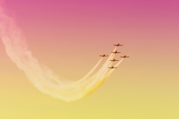 Fighter jets in the shape of in the gradient sky beautiful sunset.