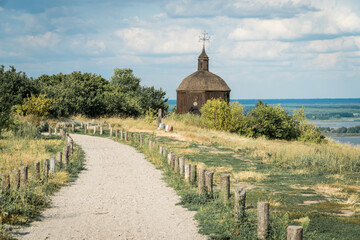 Landscape of a small wooden church on a hill with a magnificent view on a  Dneper river in Vitachov (Vytachov), Ukraine.