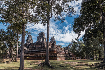 Ruins of ancient Khmer temple among trees in Angkor complex, Siem Reap, Cambodia