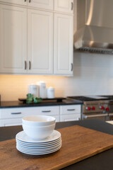 contemporary white kitchen interior with white dishes on the kitchen counter