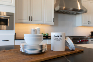 Fototapeta na wymiar modern white kitchen interior with white dishes on the wooden kitchen counter