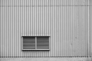 Warehouse Wall With a Window Vent in Black and White.