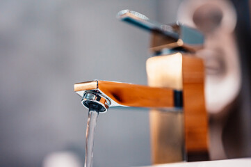 Water tap , faucet. Flow water in bathroom with sink. Modern clean hause. Hygiene concept. Panorama - obrazy, fototapety, plakaty