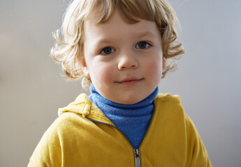 Little Ukrainian child. He is wearing blue and yellow clothes.