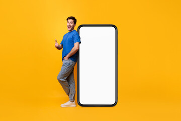 Man leaning on white blank smartphone screen showing thumbs up