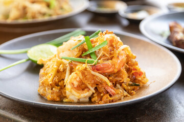 Pad Thai (Stir-fried rice noodles with shrimp) flavor with sugar, lime, ground dried chilies and...