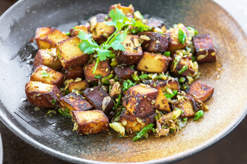 Stir-fried black tofu with chili, salt, garlic and pepper. Authentic the rare black tofu found only in Ratchaburi, Photharam Village, Thailand. Balance salty and sweet stew with sweet herbal gravy.