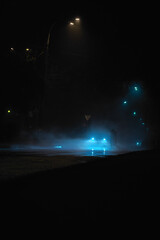 night road in the fog with car headlights