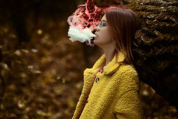 girl in autumn in the foliage in the forest with smoke