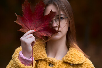 girl in the autumn in the leaves in the forest