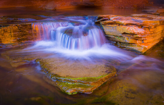 Longe exposure image of a small waterfall in a slot canyon in Karijini national park in west Australia