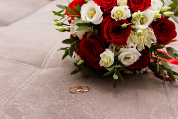 bride's bouquet, beige shoes and wedding rings. The bride's accessories.