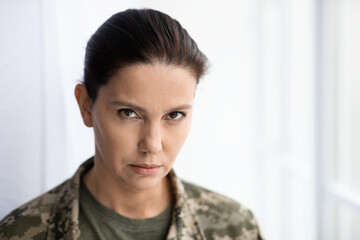 Portrait Of Serious Middle Aged Woman In Military Uniform Looking At Camera