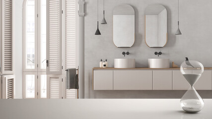 White table or shelf with crystal hourglass measuring the passing time over modern bathroom with washbasin in classic apartment, architecture interior design, copy space background