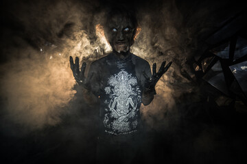 scary sorcerer in smoke. voodoo rite