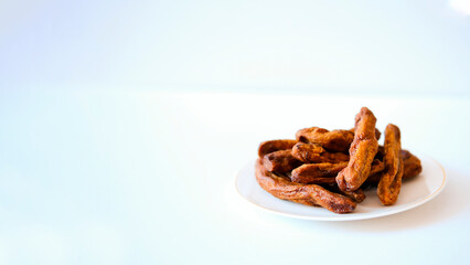 Dried bananas on a light plate. Copy space.