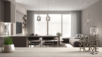 Wooden table, desk or shelf with potted grass plant, house keys and 3D letters home sweet home, over modern living and dining room, architecture interior design, copy space background