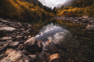 Mountains lake in autumn Dombay, and water reflection. Russia, Caucasus. October 2019.