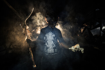 scary sorcerer in smoke. voodoo rite