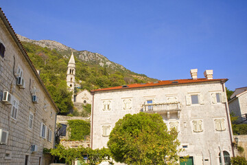 Fototapeta na wymiar Old historical buildings in sunny day in Perast, Montenegro