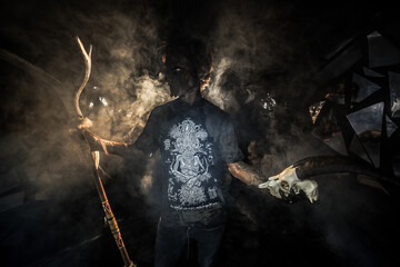 scary sorcerer in smoke. voodoo rite