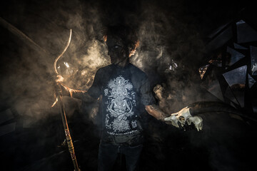 scary sorcerer in smoke. voodoo rite