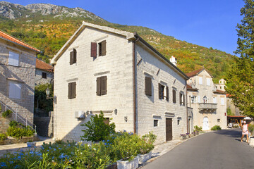 Fototapeta na wymiar Old historical buildings in sunny day in Perast, Montenegro