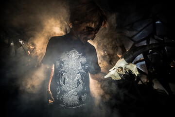 scary sorcerer in smoke. voodoo rite