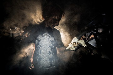 scary sorcerer in smoke. voodoo rite