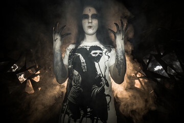 Fototapeta na wymiar the sorceress stands in the smoke. voodoo rite