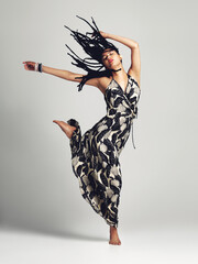 Freedom is a state of mind. Studio shot of a young woman posing against a grey background.
