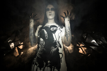 the sorceress stands in the smoke. voodoo rite