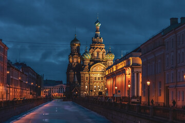 Church of the Savior on Spilled Blood (also known as Tserkovʹ Spasa na Krovi) at night in Saint Petersburg city, Russia. Griboedov Canal covered with ice. Travel in winter Russia theme.